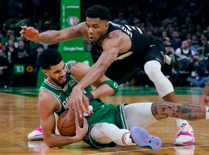 Jayson Tatum and Giannis Antentokoumnpo fight for a loose ball in the 2022 NBA Playoffs